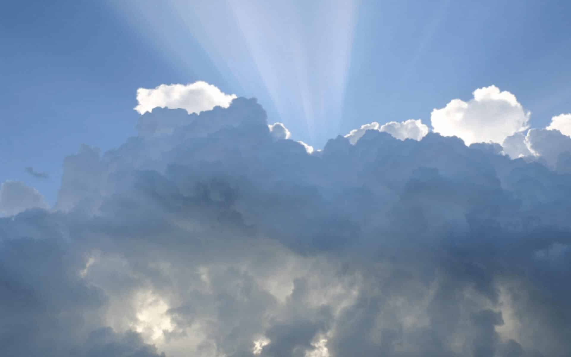 Rays of sunshine shoot above a thick cloud bank
